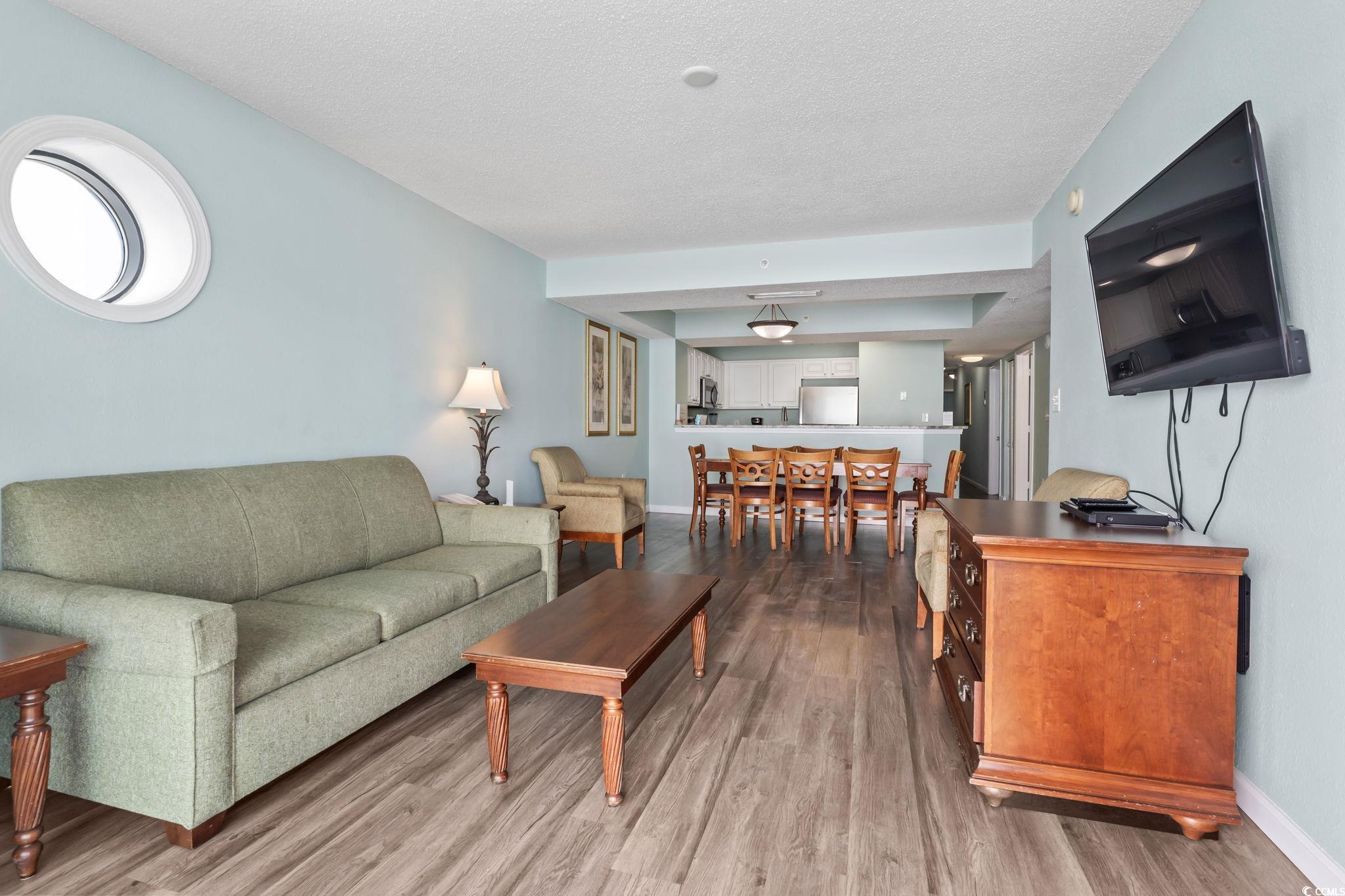 2007 South Ocean Boulevard, Unit 607 Myrtle Beach, SC 29577 - Photo 8 of 40 Living room featuring a textured ceiling, baseboar