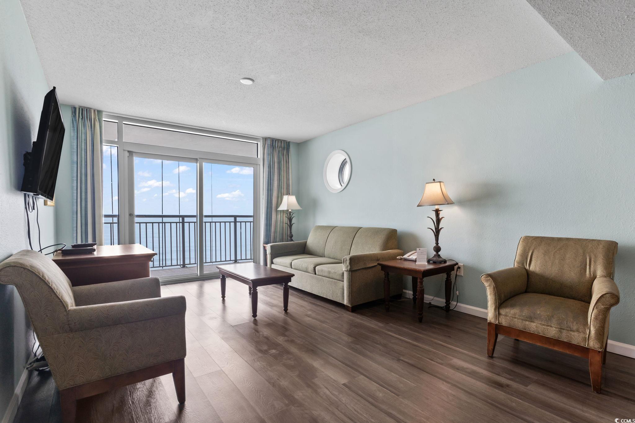 2007 South Ocean Boulevard, Unit 607 Myrtle Beach, SC 29577 - Photo 9 of 40 Living room with baseboards, wood finished floors,
