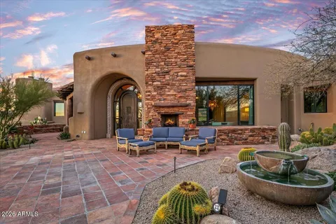 a building outdoor space with patio furniture and a potted plant