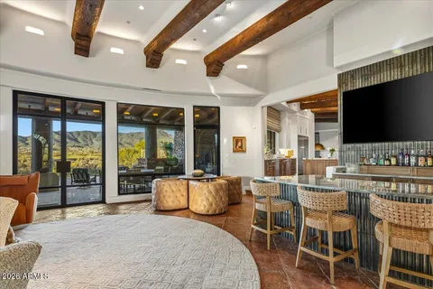 a living room with fireplace furniture and a large window