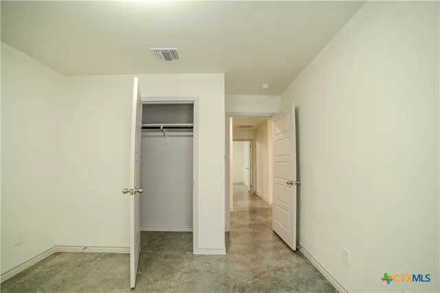 an empty room with a empty space and windows