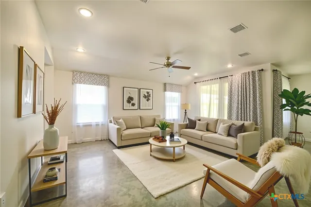 a living room with furniture and a large window