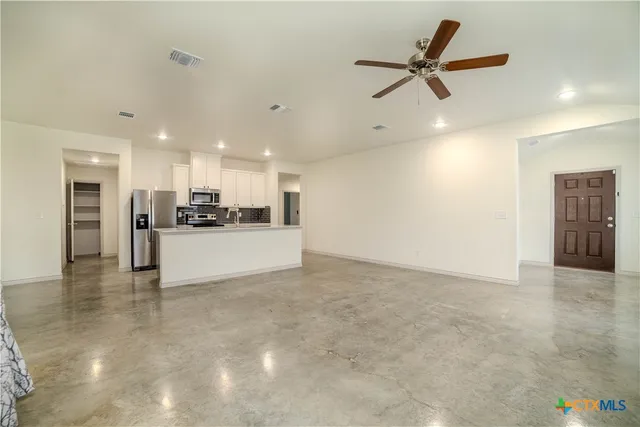 a kitchen with stainless steel appliances a refrigerator sink and stove