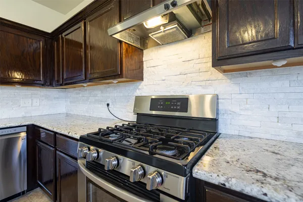 a stove top oven sitting inside of a kitchen