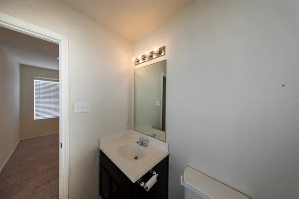 a bathroom with a sink a mirror and a toilet