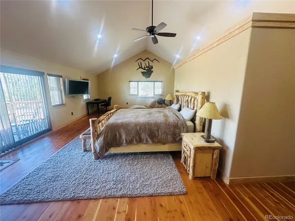 a bedroom with furniture and wooden floor