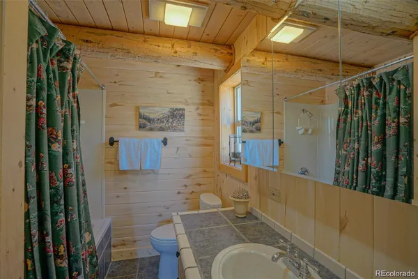 a bedroom with a bed next to a window