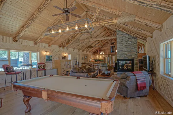 a living room with furniture a table and a fireplace