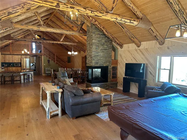 a dining room with furniture window and wooden floor