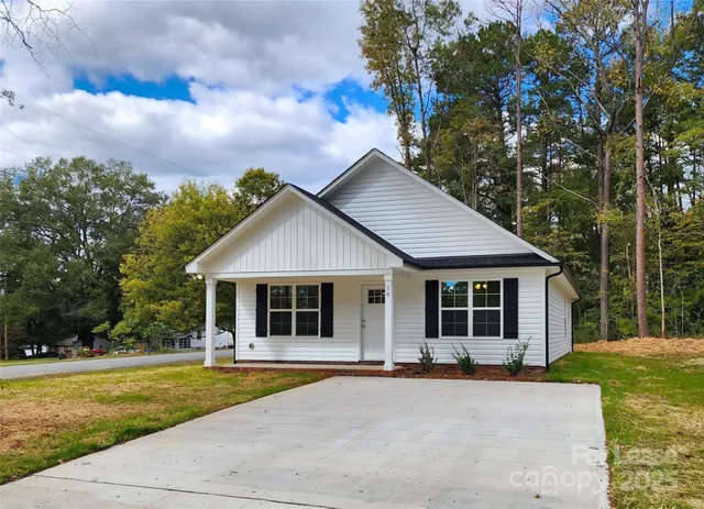 a front view of a house with yard patio and green space