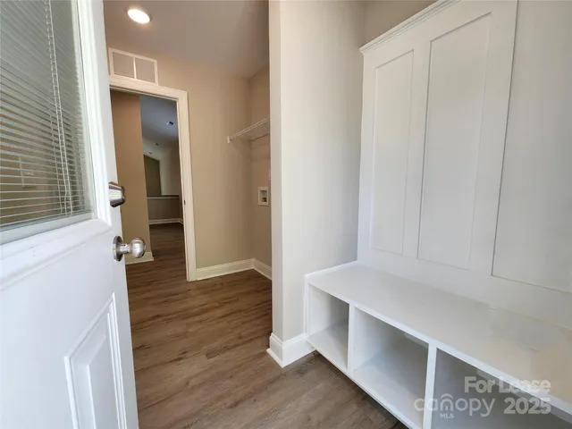 a view of hallway with wooden floor