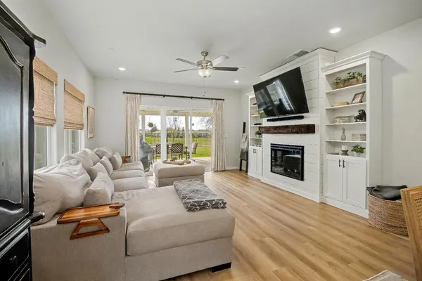 a living room with furniture a fireplace and a flat screen tv