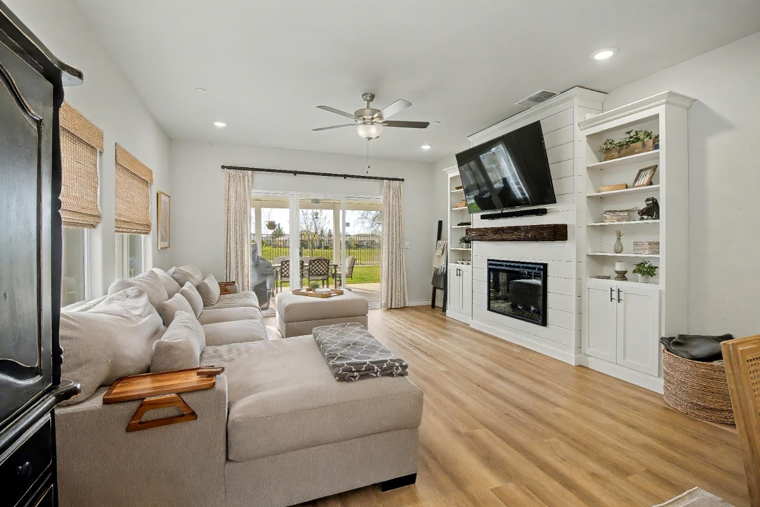 1502 Braeburn Way Ione, CA 95640 - Photo 12 of 48 a living room with furniture a fireplace and a flat screen tv