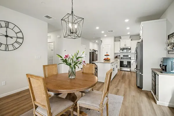 a view of a dining room with furniture and wooden floor