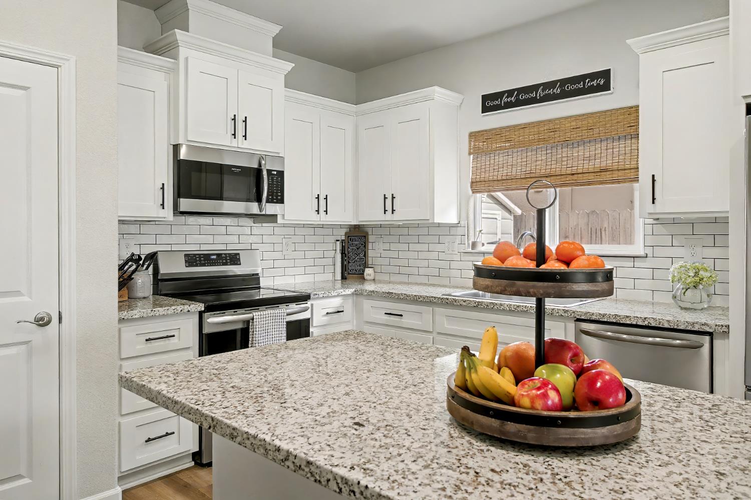 1502 Braeburn Way Ione, CA 95640 - Photo 22 of 48 a kitchen with a microwave a stove and cabinets