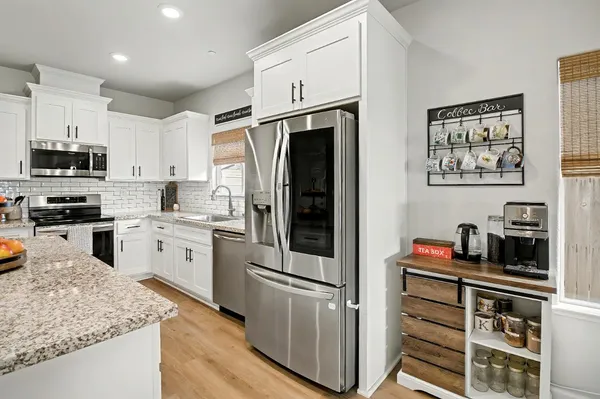 a kitchen with stainless steel appliances a refrigerator stove and sink