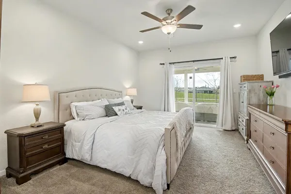a bedroom with a bed and a chandelier