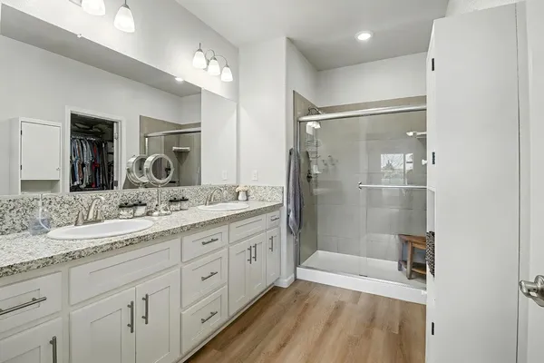 a bathroom with a granite countertop sink mirror and double