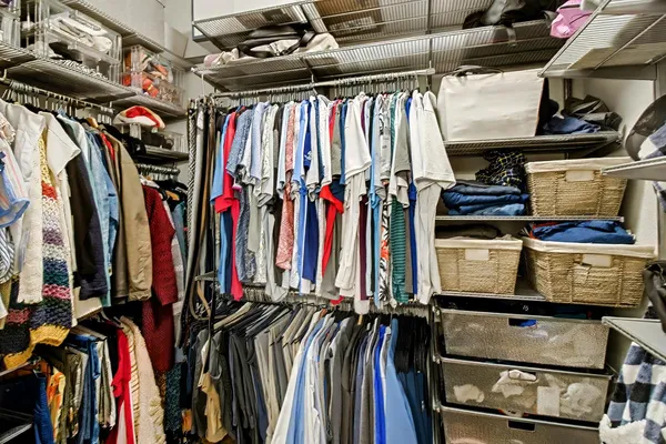 a view of walk in closet with clothes