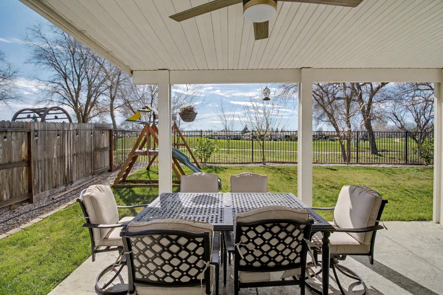 1502 Braeburn Way Ione, CA 95640 - Photo 40 of 48 a view of a patio with table and chairs with wooden floor and fence