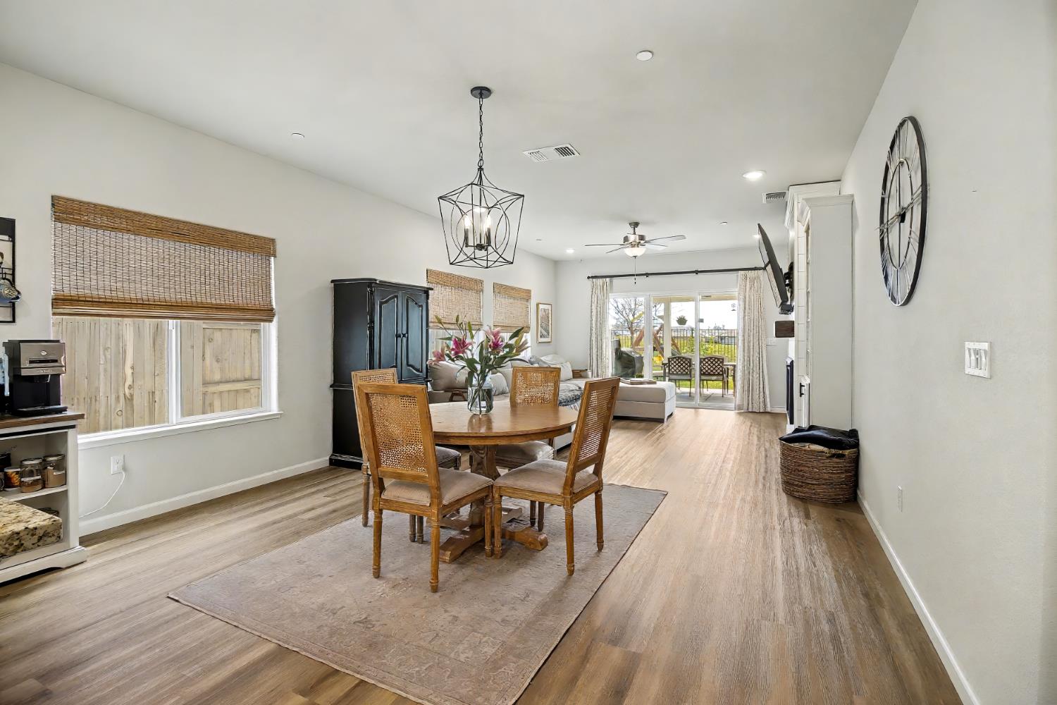 1502 Braeburn Way Ione, CA 95640 - Photo 10 of 48 a dining room with wooden floor a chandelier a wooden table and chairs