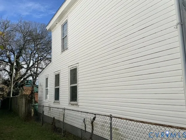 a view of a white house with many windows