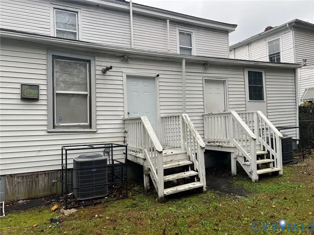 a view of a house with a large window and wooden deck