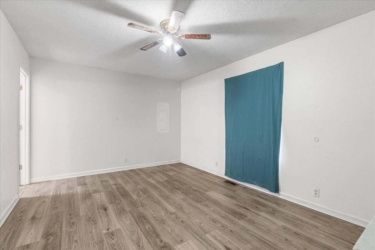 1505 Longview Road Unionville, TN 37180 - Photo 15 of 24 an empty room with wooden floor and fan