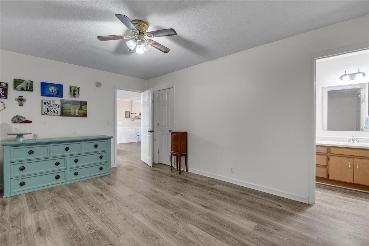 1505 Longview Road Unionville, TN 37180 - Photo 16 of 24 a view of a bedroom with cabinet cabinet and a chandelier fan