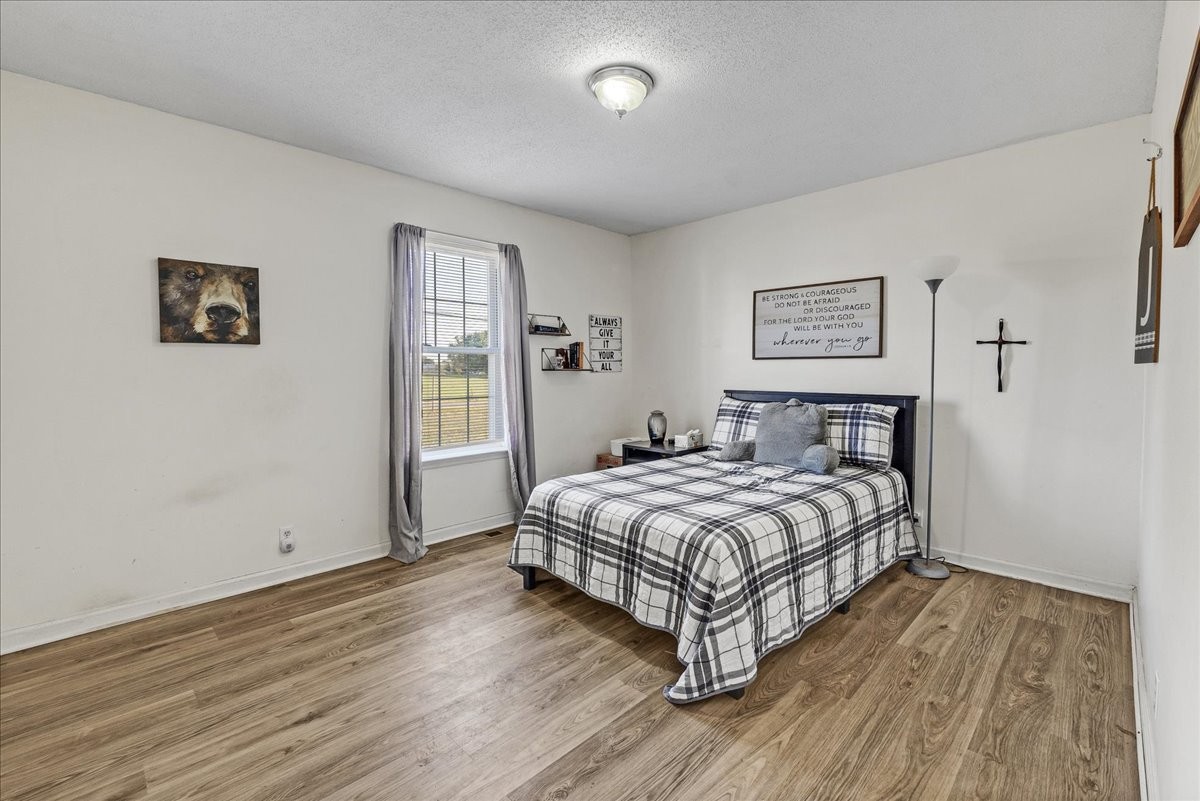 1505 Longview Road Unionville, TN 37180 - Photo 21 of 24 a bedroom with a bed and wooden floor