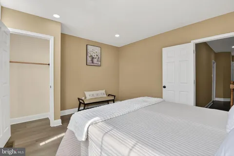 a bedroom with a bed and a refrigerator