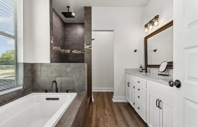 a bathroom with double vanity sinks and a mirror