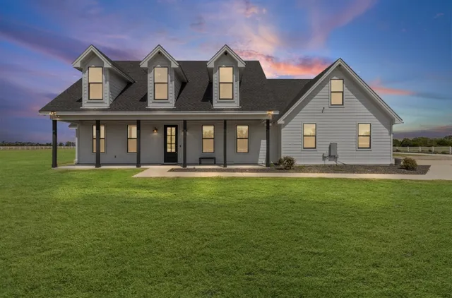 a front view of house with yard and green space