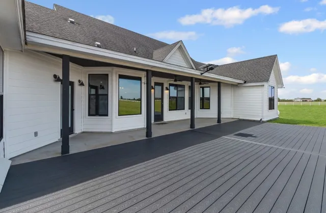 a view of a house with a big yard and potted plants