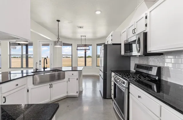a kitchen with stainless steel appliances wooden cabinets and a stove