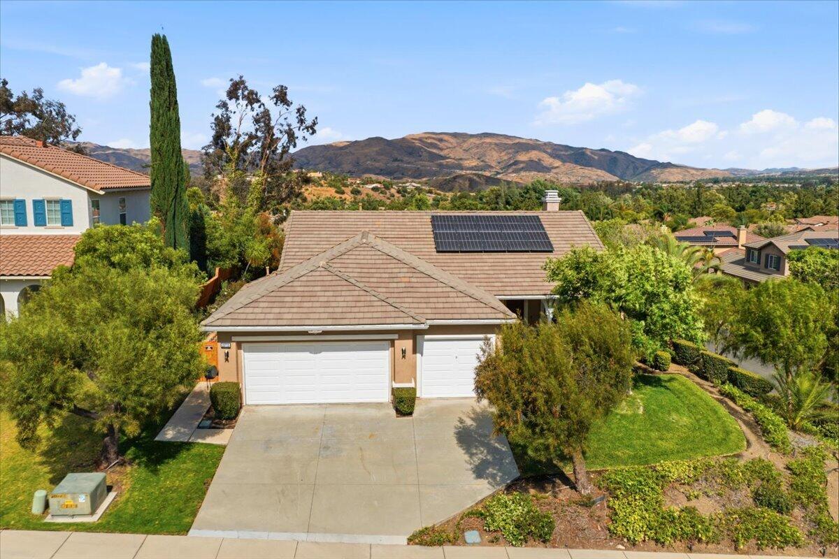 23732 Bella Vista Road Corona, CA 92883 - Photo 39 of 49 a front view of a house with a yard and mountain view in back