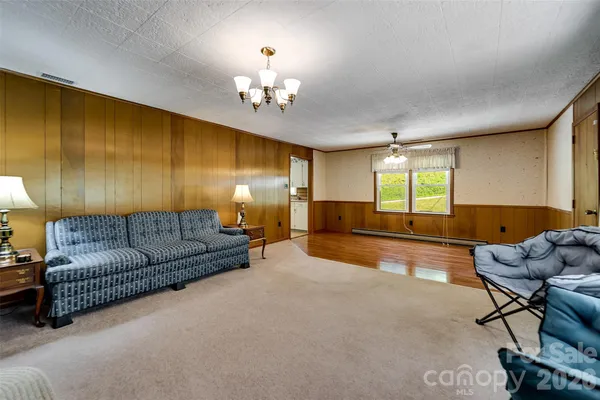 a living room with furniture and kitchen view