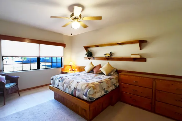 a bedroom with a large bed and a window