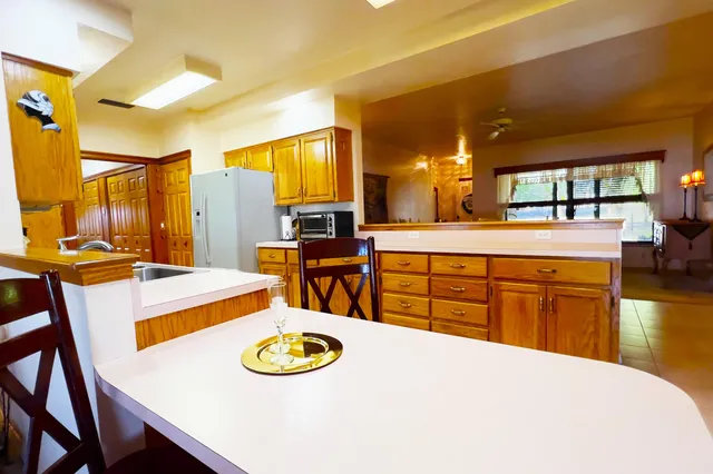 a living room with furniture ceiling fan and a window