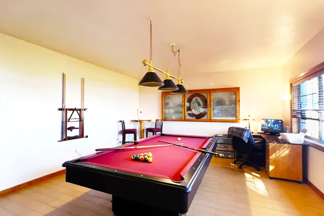 a room with a table chairs and wooden floor