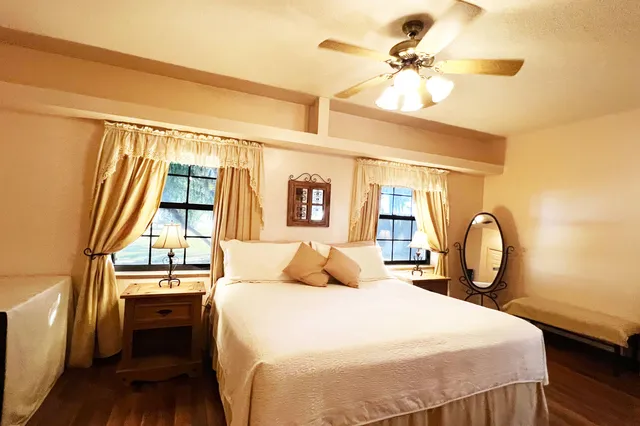 a bedroom with a bed and a window