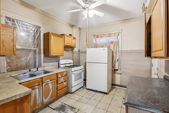 a kitchen with a stove a refrigerator and a sink