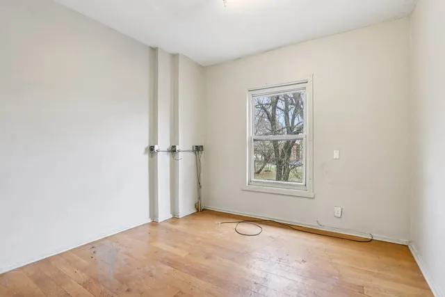 an empty room with windows and closet