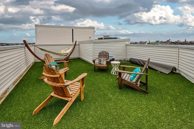 a room with gym equipment and wooden floor