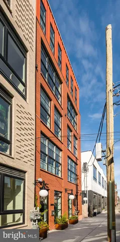a front view of a house with a potted plant