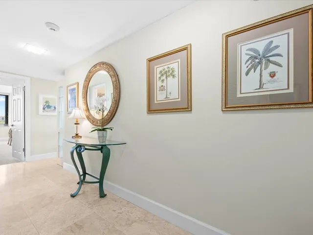 a view of a hallway with paintings on the wall