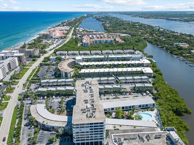 an aerial view of multiple houses with yard