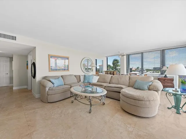 a living room with furniture and a floor to ceiling window