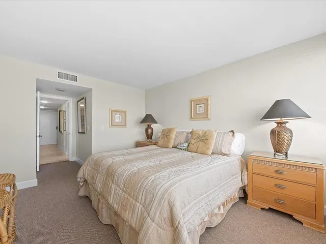 a bedroom with a bed and lamp