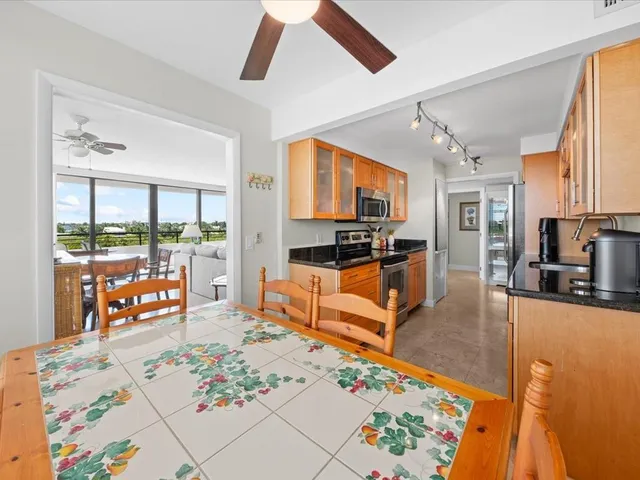 a kitchen with stainless steel appliances kitchen island granite countertop a refrigerator and microwave